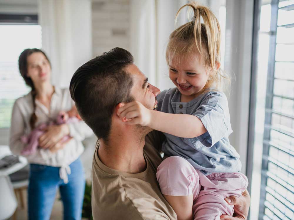 A young Canadian family, happy and together, as they find some relieve with the support of government benefit programs and in knowing the dates they pay.